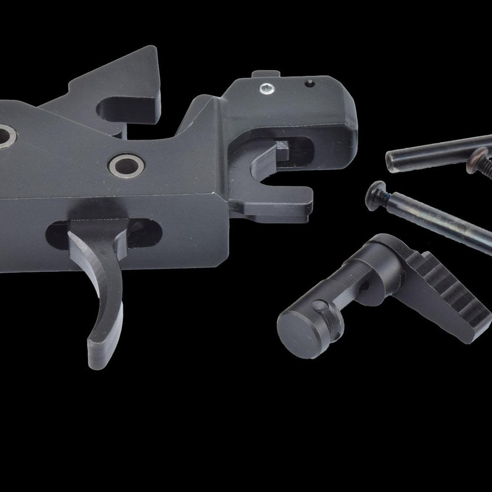 Drop-in cassette trigger assembly and selector components on a black background