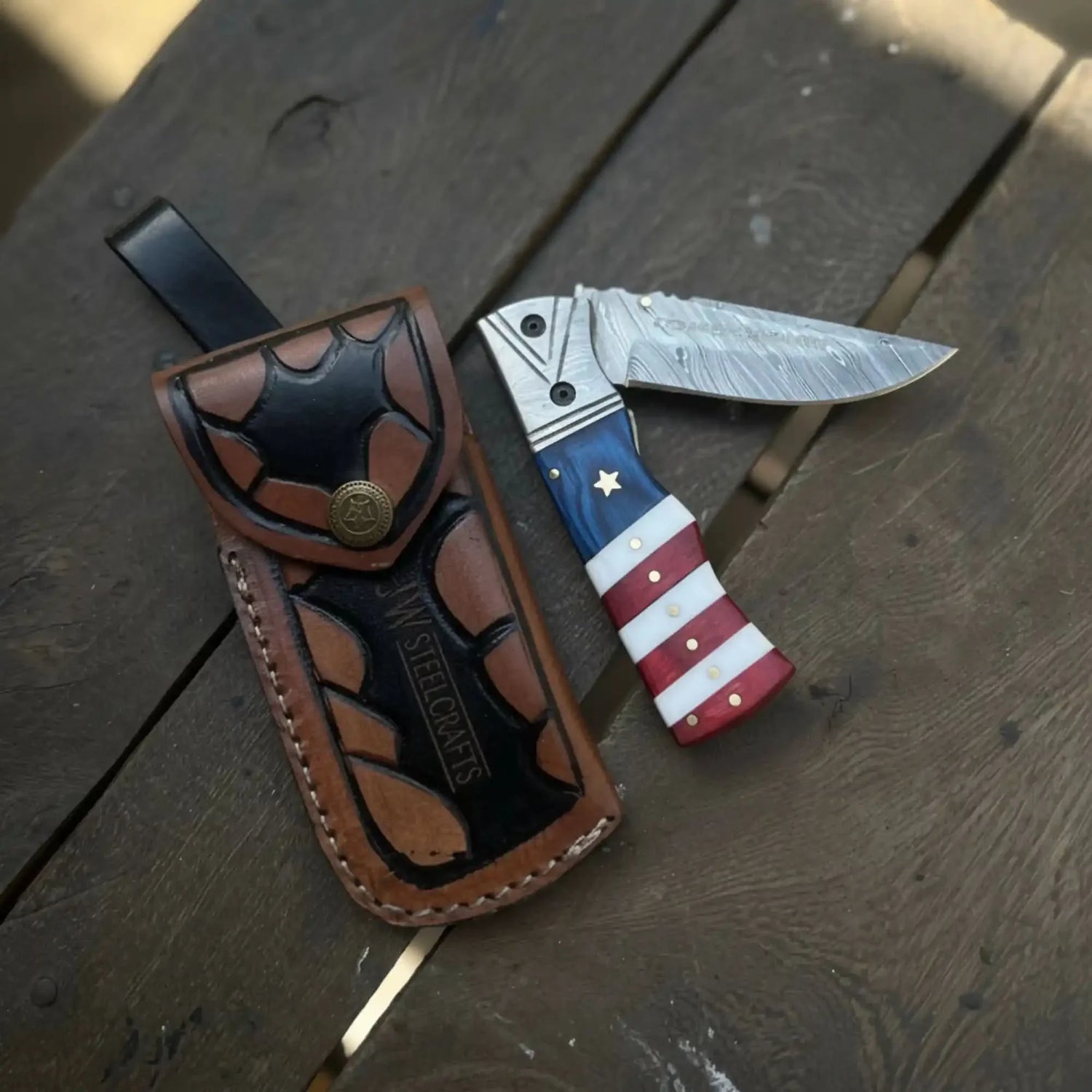 Damascus Folding Pocket Knife — American Flag Handle, Damascus Bolster, Linear Lock &amp; Hand Engraved Leather Sheath