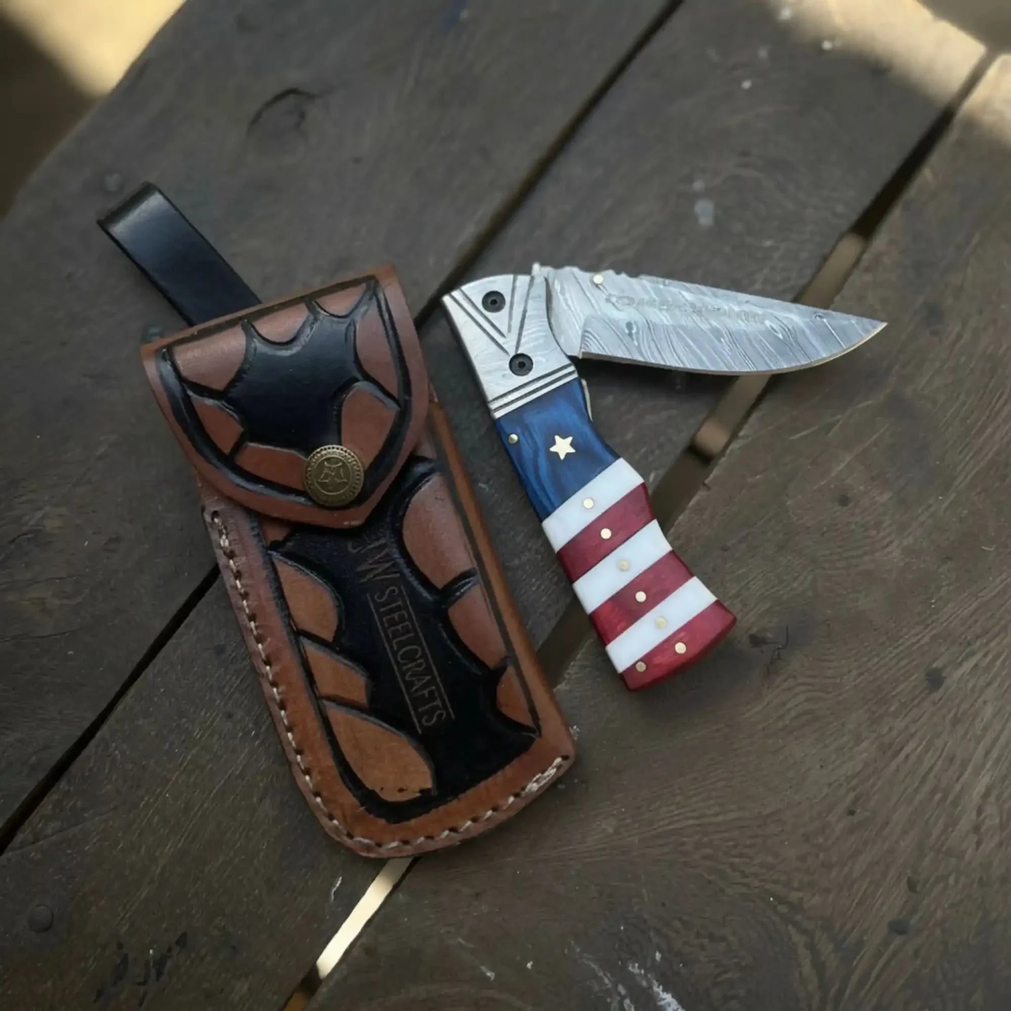 Damascus Folding Pocket Knife — American Flag Handle, Damascus Bolster, Linear Lock &amp; Hand Engraved Leather Sheath