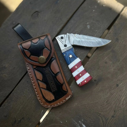 Damascus Folding Pocket Knife — American Flag Handle, Damascus Bolster, Linear Lock &amp; Hand Engraved Leather Sheath
