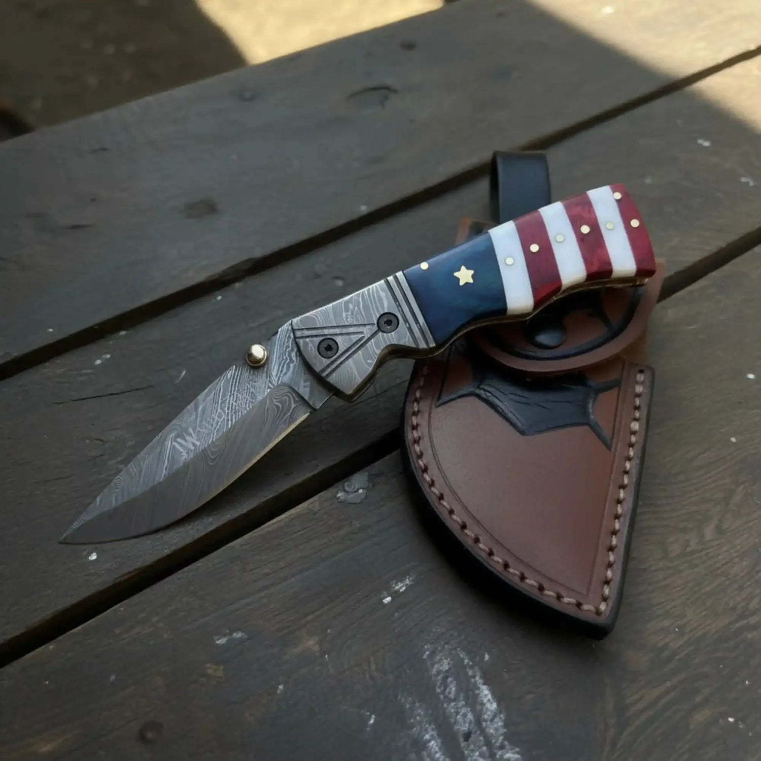 Damascus Folding Pocket Knife — American Flag Handle, Damascus Bolster, Linear Lock &amp; Hand Engraved Leather Sheath