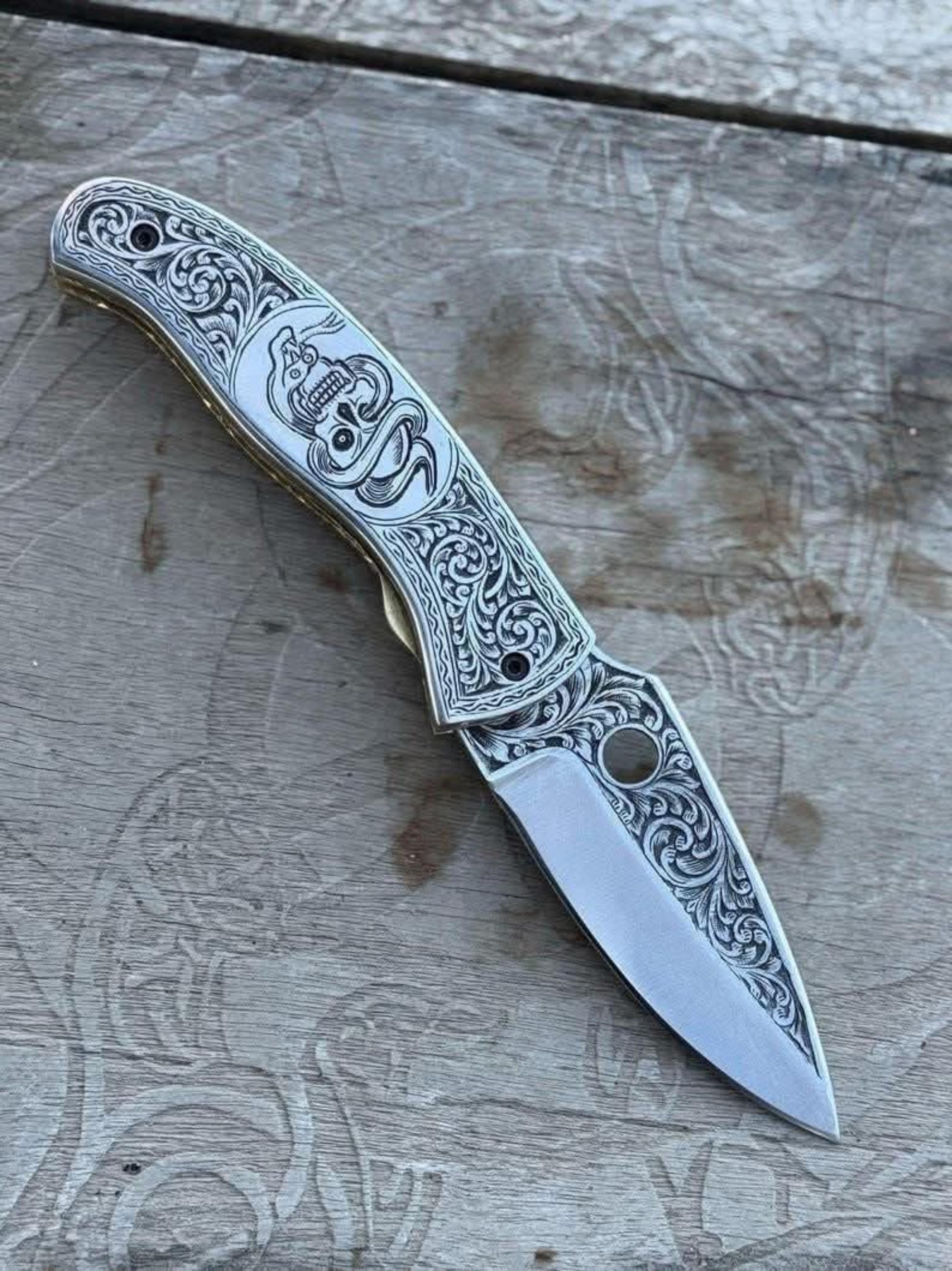 Engraved Scrollwork Folding Knife with Silver Finish and Detailed Blade Etching