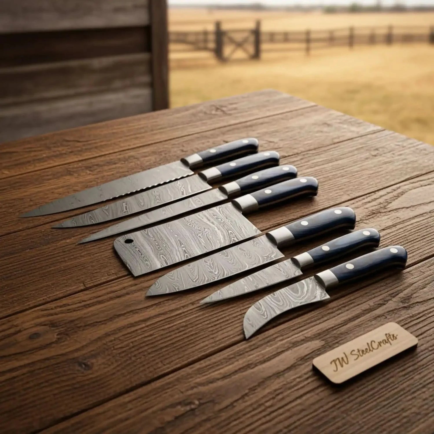 7-Piece Outdoor Damascus Kitchen Knife Set with Meat Cleaver &amp; Serrated Bread Knife — Black Resin Handles, Steel Bolsters &amp; Leather Roll | JW Steel Crafts